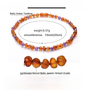 Detail view of natural Baltic amber baby necklace with cognac beads and amethyst accents