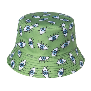 Close-up of green bucket hat featuring embroidered eye patterns and canvas texture detail