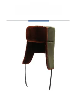 Close-up of army green winter trapper hat featuring warm brown faux fur lining