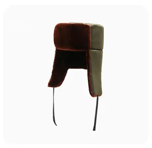 Detail view of olive green trapper hat with thick reddish-brown faux fur lining