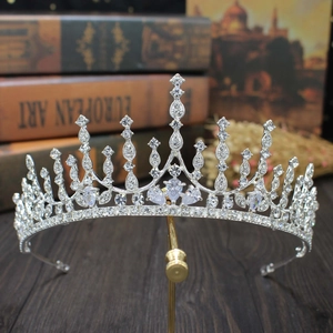 Elegant silver bridal crown with sparkling rhinestones on a display stand for weddings