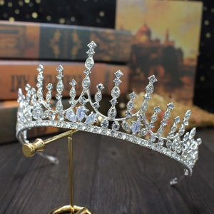 Elegant bridal crown with silver finish and shimmering crystals on a vintage background