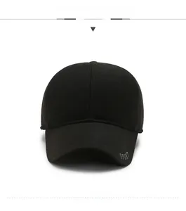 Detail view of the black baseball cap featuring a SPORT metallic tag and side silk printing