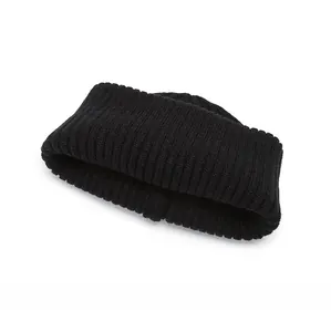 Detail view of the black knit beanie showing the thick ribbed texture and elastic warm fabric