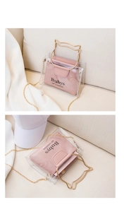 Detail of pink jelly bag with golden cat-shaped metal handle and gold chain strap