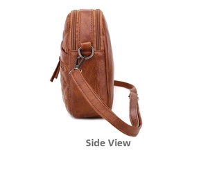 Side view of dark brown quilted crossbody bag with multiple zipper layers and metal hardware