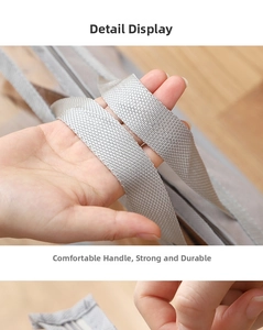 Close-up of durable reinforced gray woven handles on a PVC handbag storage bag