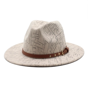 Detail of fedora hat with black geometric patterns and studded brown leather strap