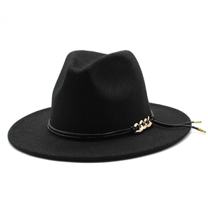 Detail of black fedora wool hat with gold chain accent and leather strap decoration