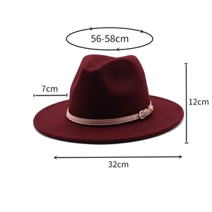 Detail showing the burgundy wool fedora hat with beige leather strap and gold buckle