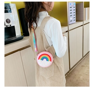 Close-up of pink silicone rainbow crossbody bag for kids with adjustable gradient strap