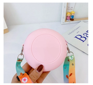 Detail of pink silicone round crossbody bag with colorful donut print strap for kids