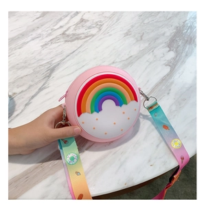 Pink silicone round bag with 3D rainbow detail and colorful printed shoulder strap