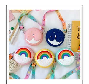 Detail of colorful silicone kids crossbody bags with 3D rocket and rainbow designs