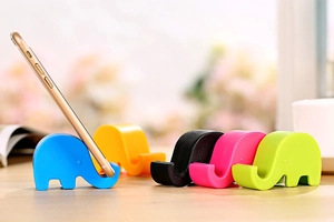 Detailed view of colorful elephant-shaped phone holders in blue, pink, and green