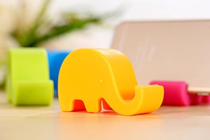 Cute elephant phone holder featuring colorful matte design with functional trunk slot