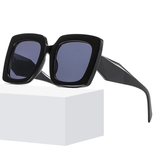 Classic oversized square sunglasses with black frame and dark lenses on display stand