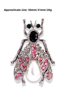 Detail view of crystal insect brooch with pearls and colorful rhinestones on silver alloy