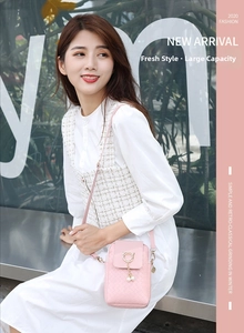 Pink woven phone bag with golden cat ear metal ring and pearl charm detail