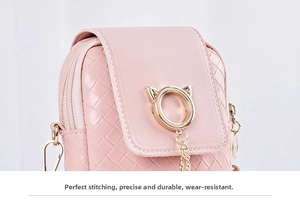 Detail of pink crossbody phone bag with woven texture and gold cat-ear buckle