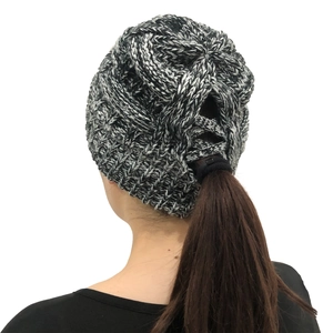 Close-up of black and white knit ponytail beanie showing the functional hole for hair