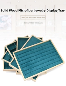 Detail of teal velvet and solid wood jewelry trays for rings and necklaces