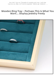 Detail view of wood jewelry tray with blue velvet slots holding multiple rings