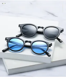Close-up of vintage round frame sunglasses with metal studs and tinted lenses
