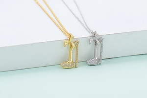 Detailed view of gold and silver high heel pendants with micro-pave crystal settings