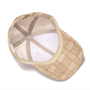 Detail view of the khaki plaid baseball cap interior lining with cotton wash label