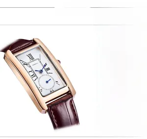 Detail of rose gold rectangular watch with multi-faceted crystal and Roman numerals