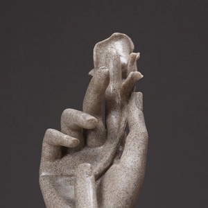 Artistic sandstone hand sculpture holding a rose flower for home and living room decor