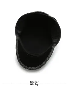 Detail view of the soft black inner lining and hemmed edges of the winter flat cap