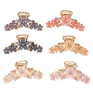 Set of six flower claw clips with cat-eye resin petals and crystals in various colors