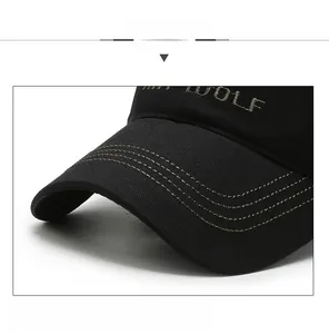 Detail of WOLF letter embroidery and reinforced brim on black cotton baseball cap
