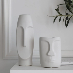 Set of two Nordic white ceramic vases with minimalist abstract face designs for decor