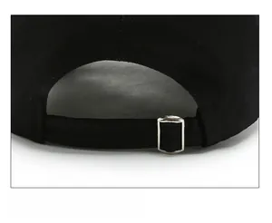 Detail of adjustable metal buckle and black canvas fabric on the baseball cap