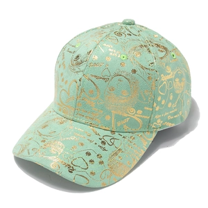 Detail of mint green baseball cap featuring gold foil floral graffiti and Rapunzel text