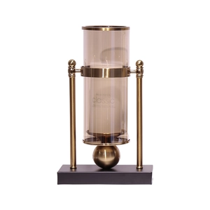 Modern gold metal candle holder with tinted glass and white scented candle for home decor