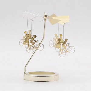 Rotating tea light candle holder with golden cyclist pendants and relief glass base