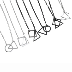 Detail of geometric silver and black titanium necklaces with square and triangle pendants