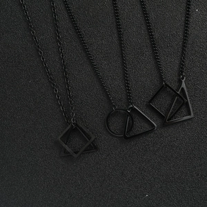 Detailed view of three black titanium necklaces with interlocking geometric pendants