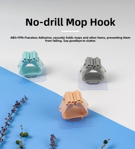 Detail of ABS and TPR adhesive mop holder clips in various colors for wall mounting