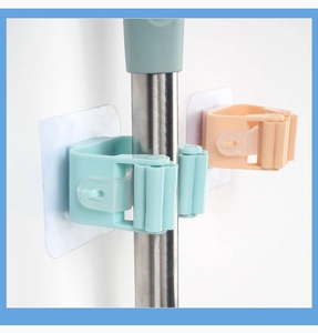 Detail of self-adhesive mop holders showing the roller mechanism and strong wall mounting