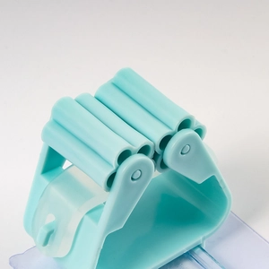 Blue wall-mounted plastic mop holder with roller slots and damage-free adhesive backing