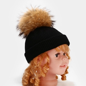 Kids black ribbed knit beanie with a large faux fur pom-pom for winter warmth