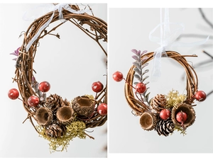Detail of Christmas wreath with red berries, pine cones and natural woven rattan vine