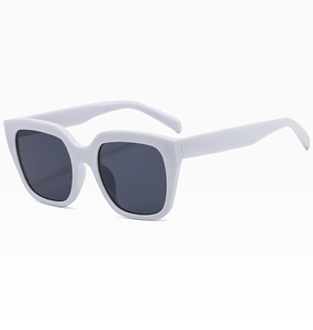 Detail shot of oversized white square sunglasses with thick frames and dark lenses