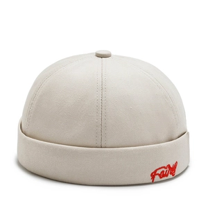 Close-up of beige docker hat showing detailed red Fairy embroidery and twill cotton fabric