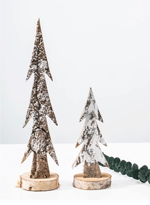 Pair of wooden Christmas trees with rustic bark texture and white snow effect decor